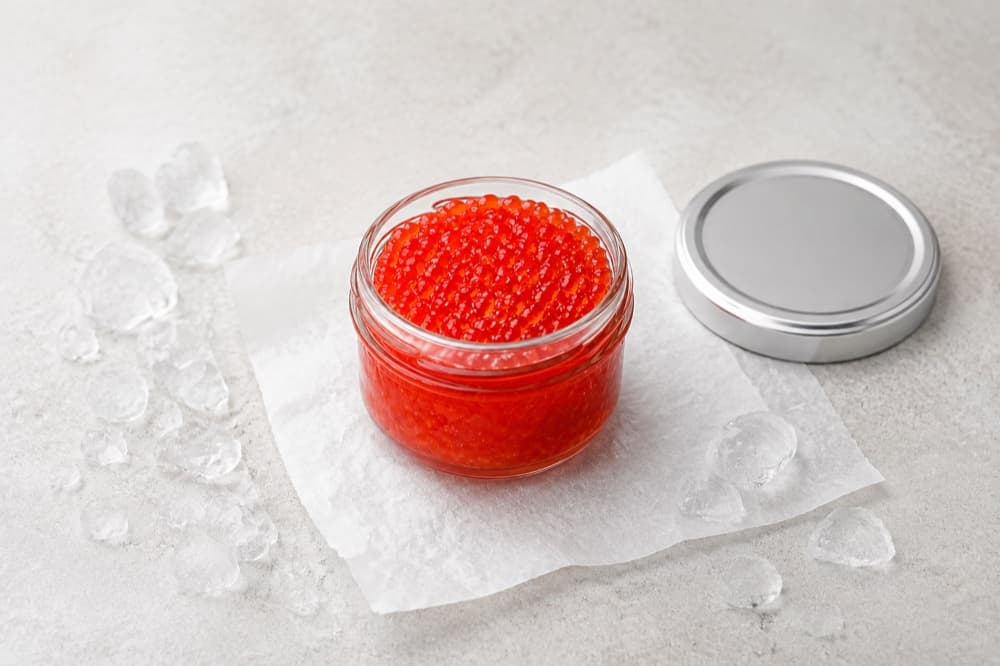 Red trout caviar in a glass jar